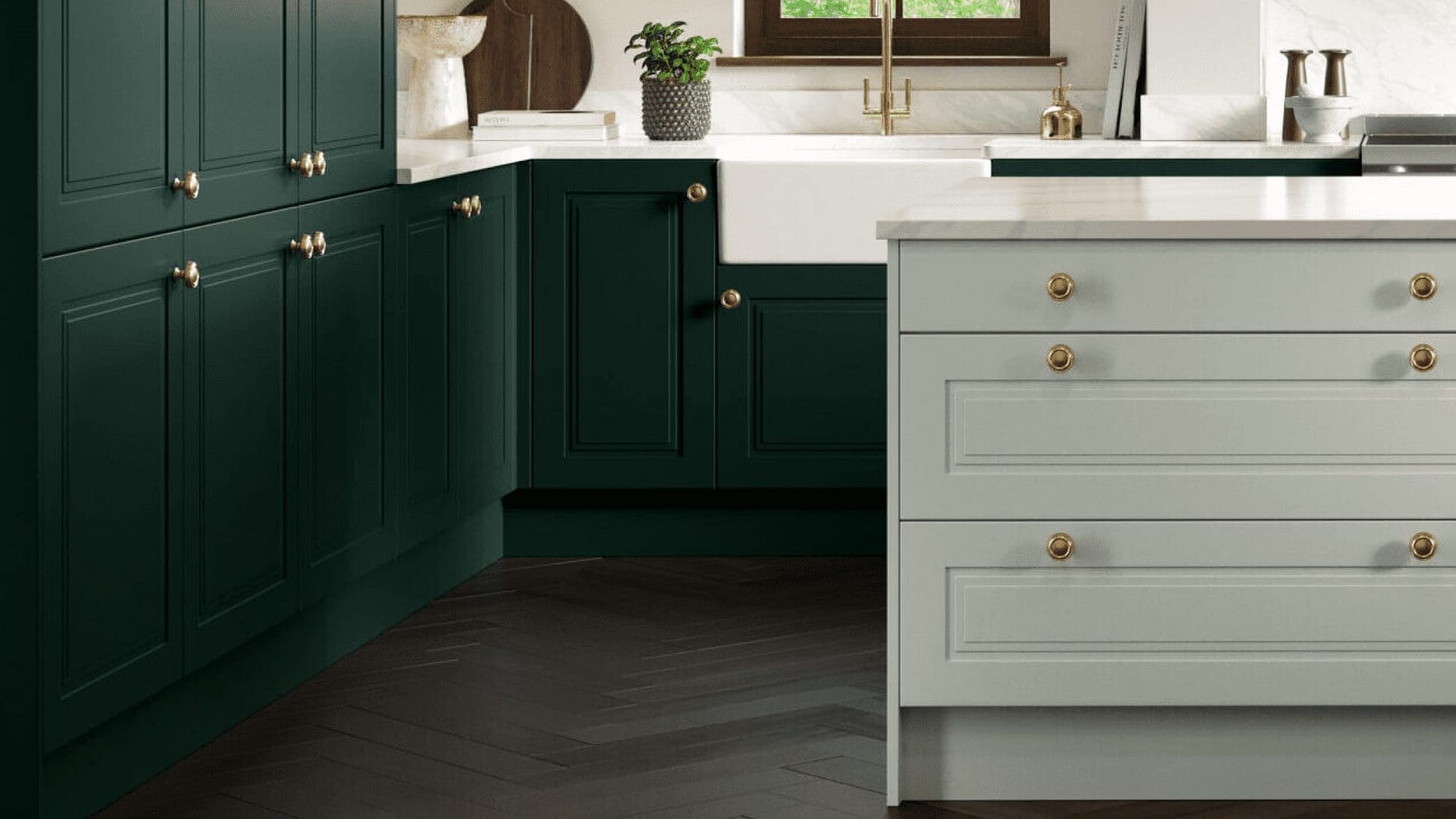 Green and grey kitchen cabinets with gold handles in a contemporary kitchen setting.