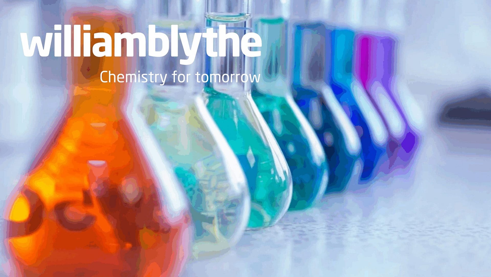 Colourful laboratory glassware with chemicals, representing William Blythe's chemical expertise.